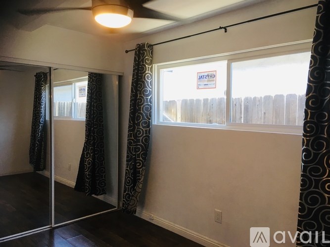 A room with a window and a sign that says "Available".