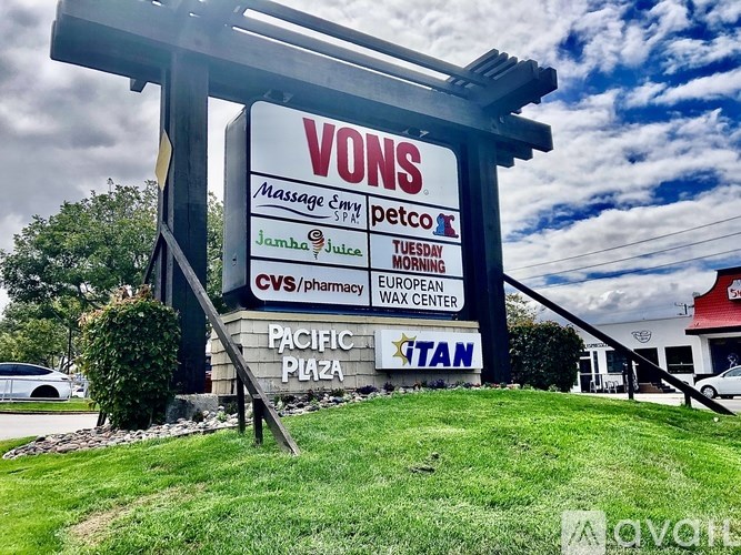 A large sign for VONS Massage Spa is displayed in front of a building.