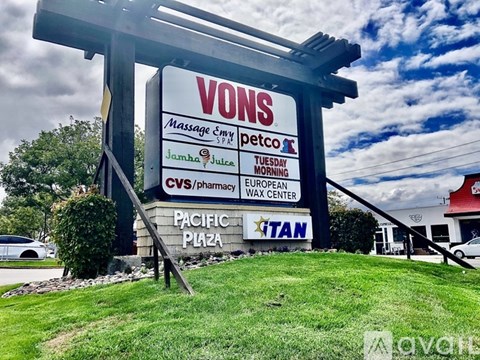 A large sign for VONS Massage Spa is displayed in front of a building.