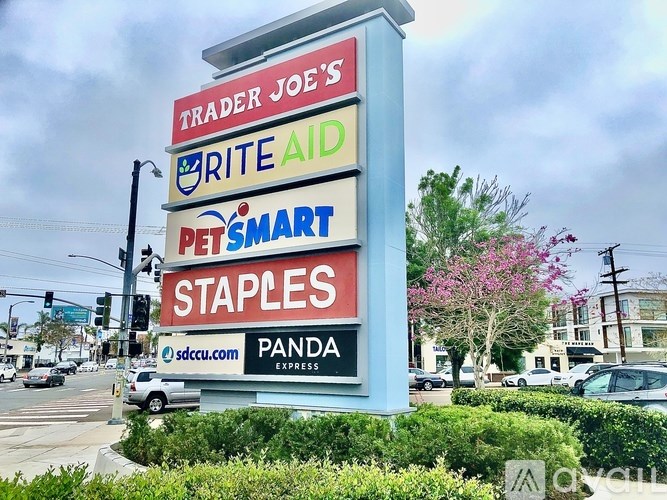 A sign for Trader Joe's is displayed in front of a building.