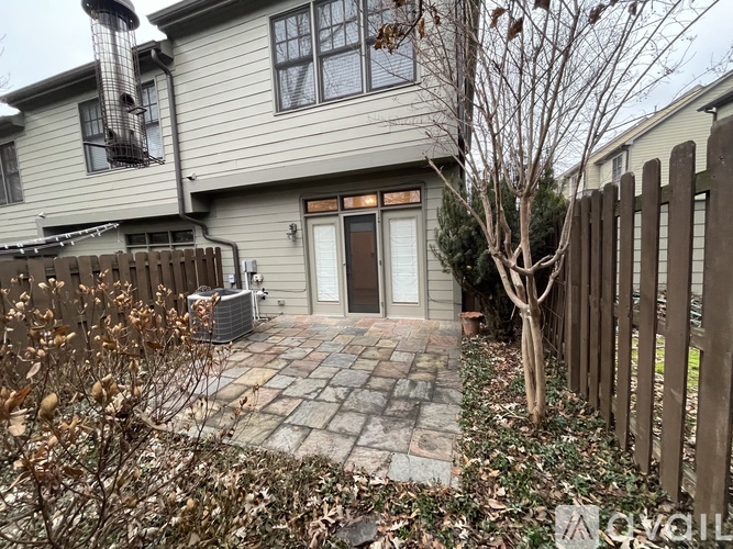 A house with a grey exterior and a brown fence.