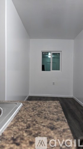 A room with a window and a marble floor.