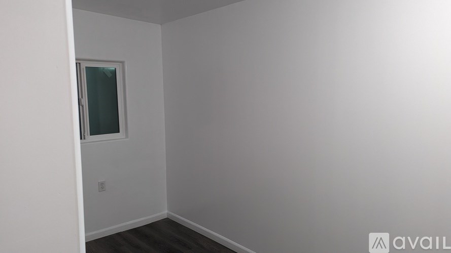 A room with a window and a door.