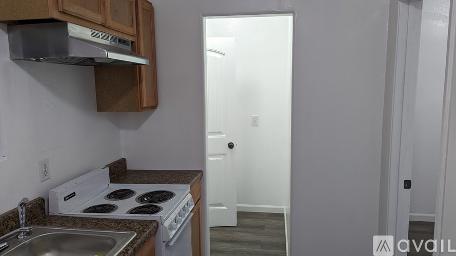 A kitchen with a stove and a sink.