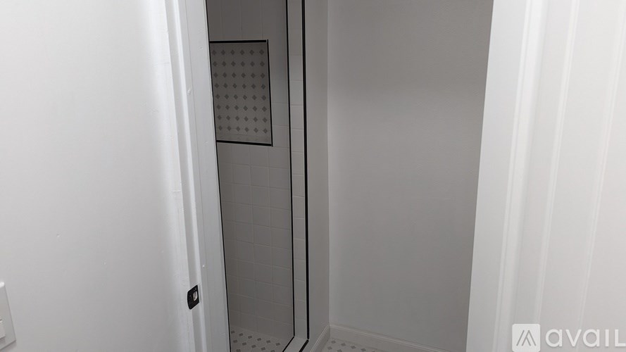 A white bathroom with a shower stall.