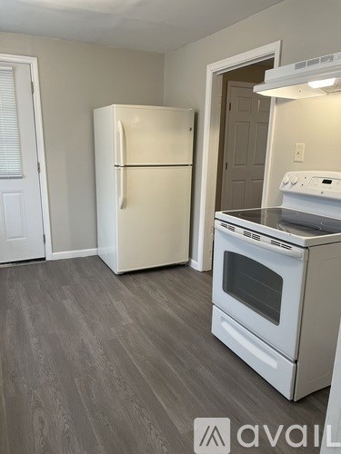 A kitchen with a white fridge and stove.