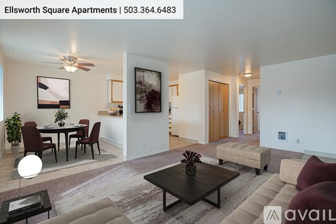 A living room with a dining table and chairs, and a painting on the wall.