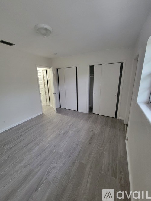 A room with a light grey floor and white walls.