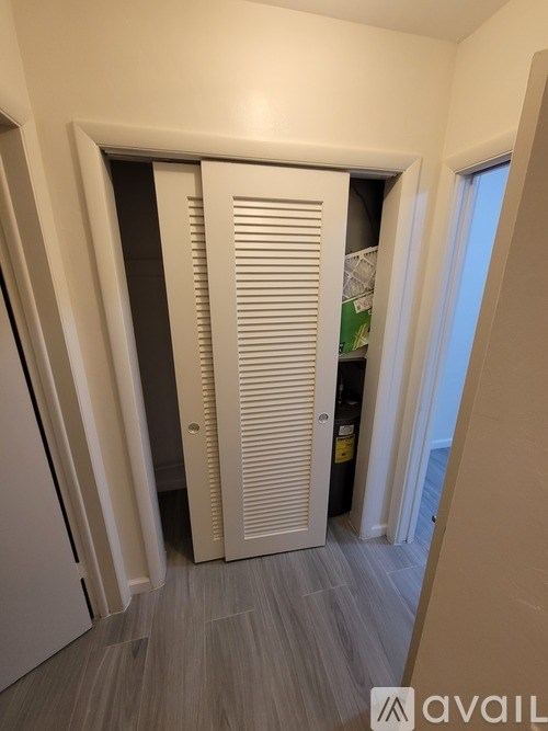 A white door with a window on the right side.