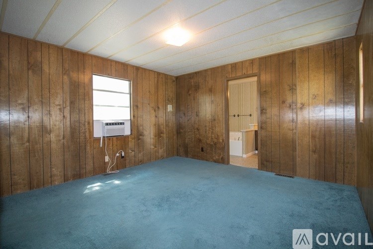 A room with wooden walls and a blue floor.