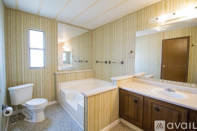 A bathroom with a toilet, sink, and bathtub.