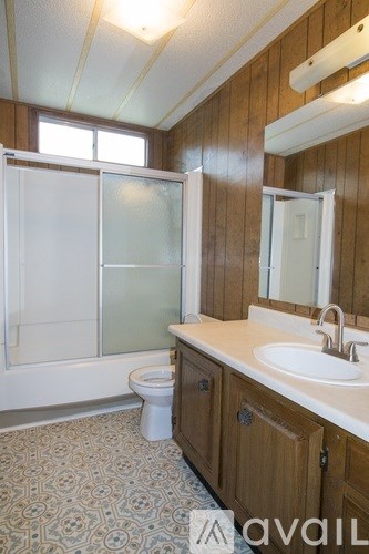 A bathroom with a toilet, sink, and shower.