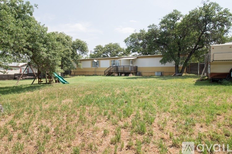 A grassy field with a building in the background.