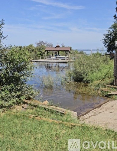 A small house is situated on the edge of a body of water.