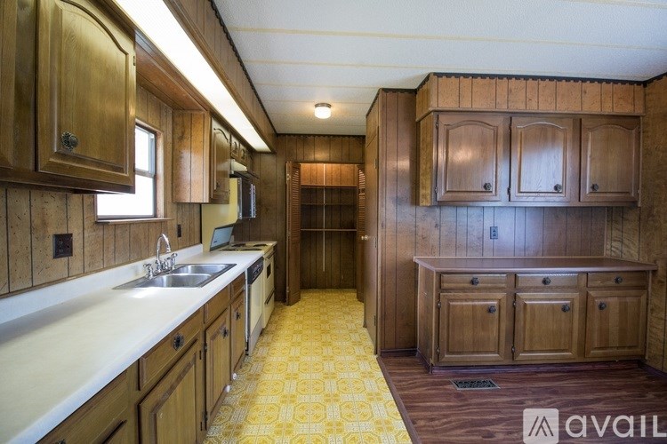 A kitchen with wooden cabinets and a sink.