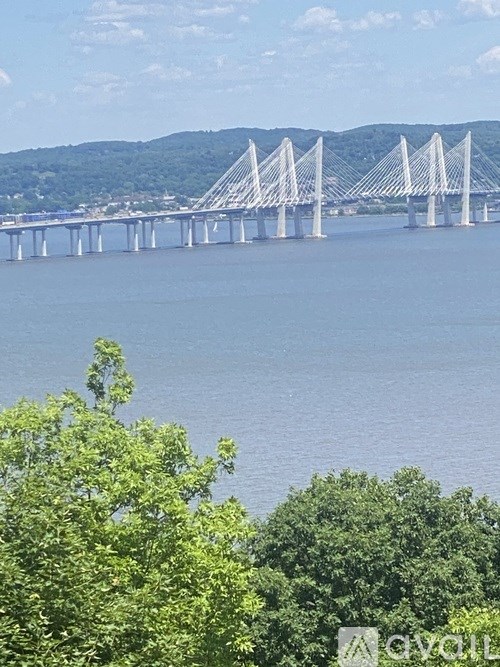 A large white bridge spans across a body of water.