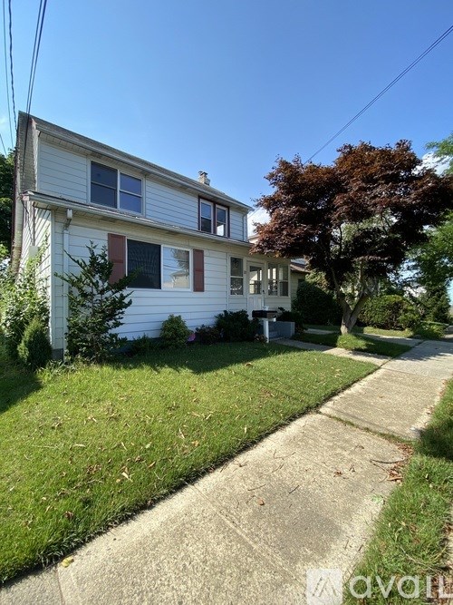 A white house with a red stripe on the front.