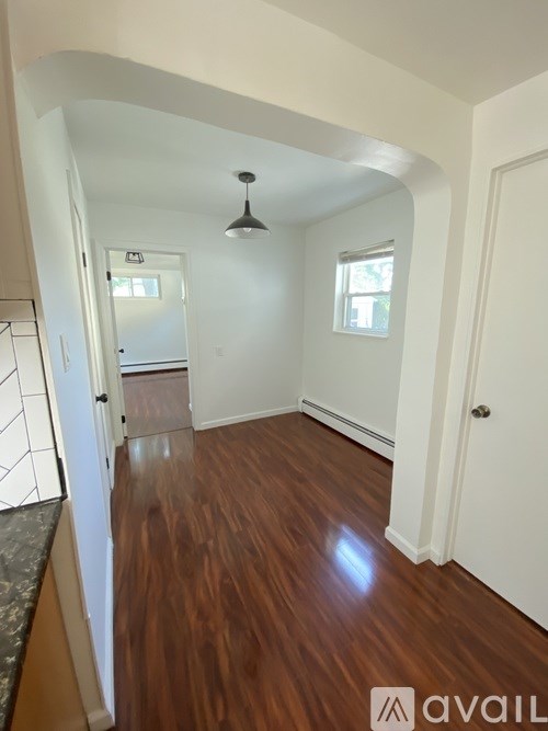 A room with wooden floors and white walls.