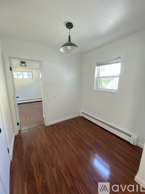A room with wooden floors and white walls.