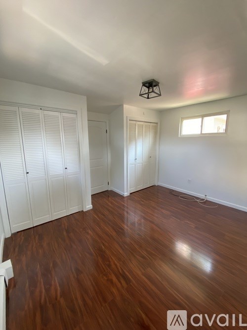 A room with wooden floors and white walls.