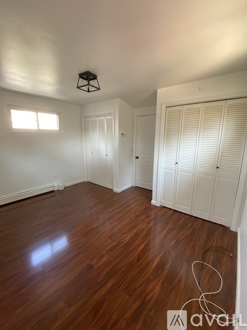A room with wooden floors and white walls.