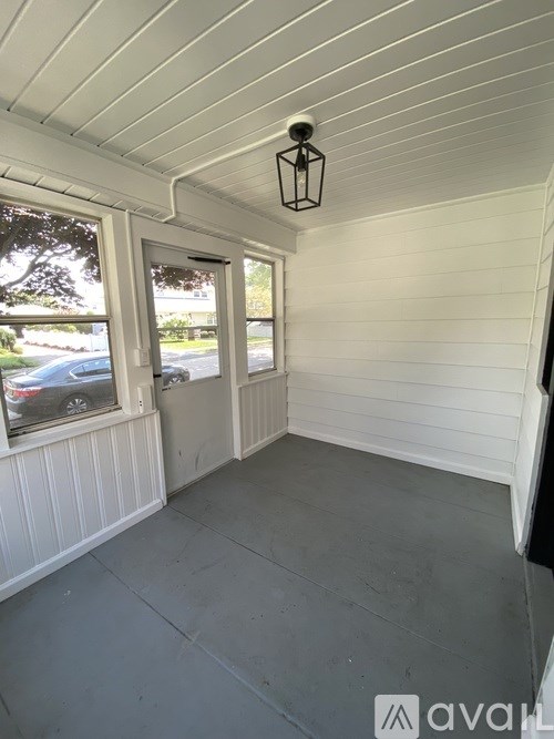 A room with white walls and a grey floor.