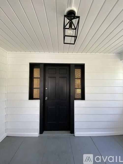 A black door with a window above it.