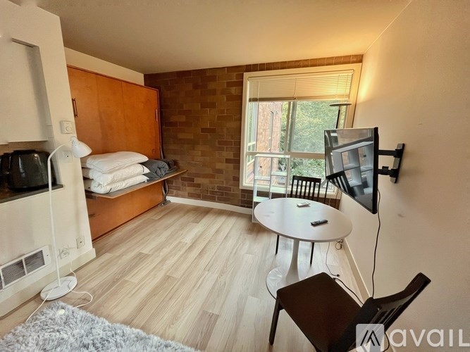 A living room with a white table and a television.