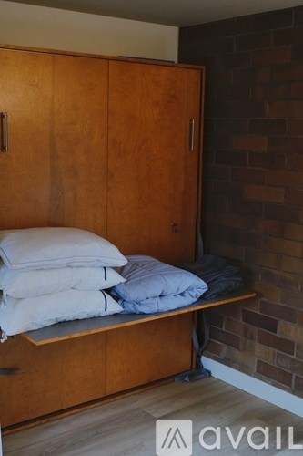 A wooden bench with towels on it.