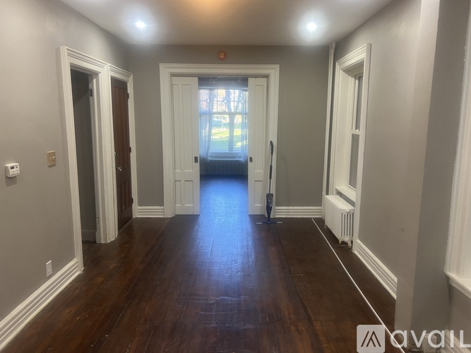 A room with wooden floors and white trim.