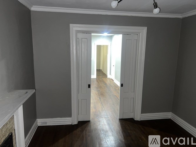 A room with a doorway leading to another room.