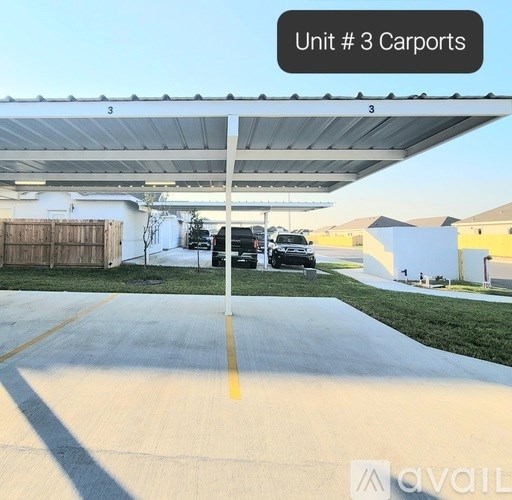 A parking area with a sign that says "Unit # 3 Carports".
