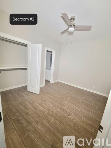 Bedroom #2 has a ceiling fan and wood flooring.