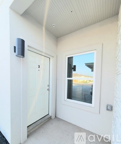 A white door with a window on the side of a house.