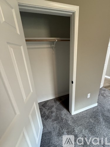 A white door is open to a small closet.