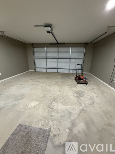 A room with a grey floor and a window with a white shutter.