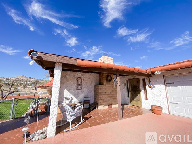 A house with a patio and a rocking chair.