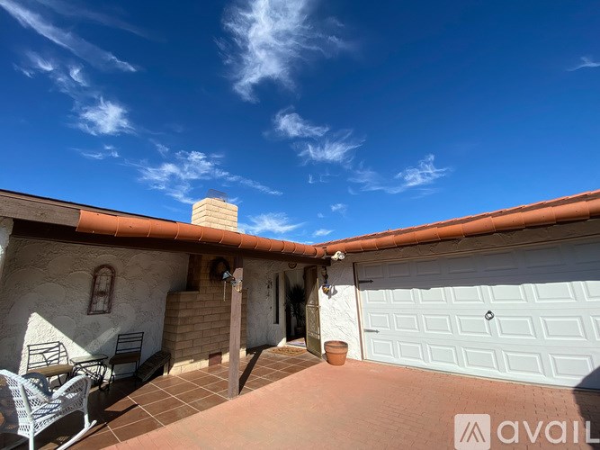 A house with a white garage door and a chimney.