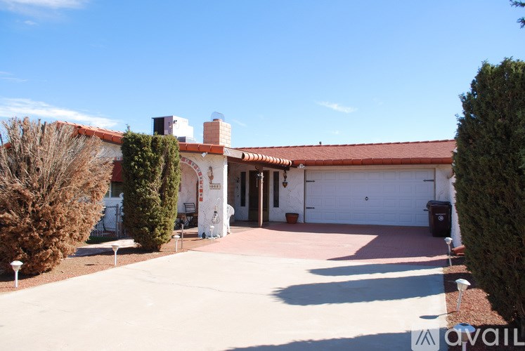 A house with a red roof and a white garage door.