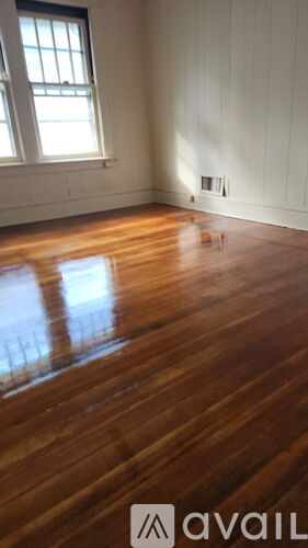A room with wooden floors and a window.