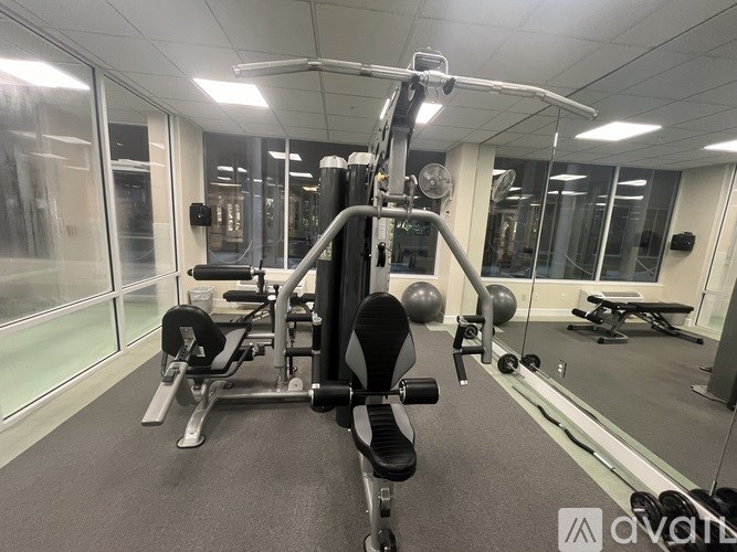 A gym with a variety of equipment including a leg press machine.