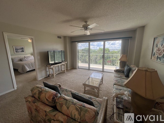 A living room with a couch, chair, and television.
