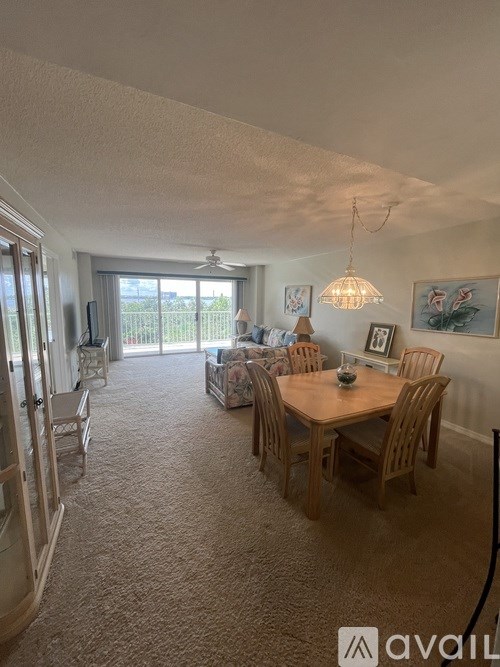 A dining room with a table and chairs.