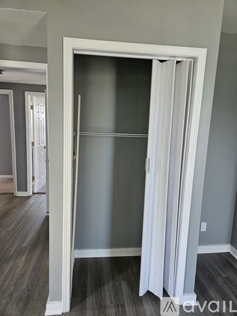 A white door with a glass panel and a white curtain.