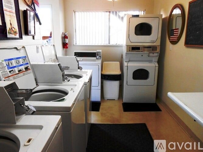 A small laundry room with a washer and dryer stacked on top of each other.