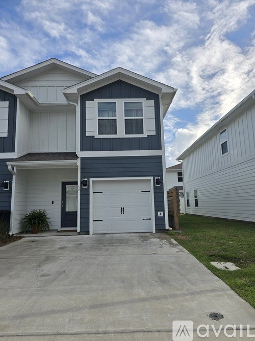 A two-story house with a garage is for sale.