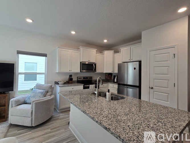 A kitchen with granite countertops and stainless steel appliances.