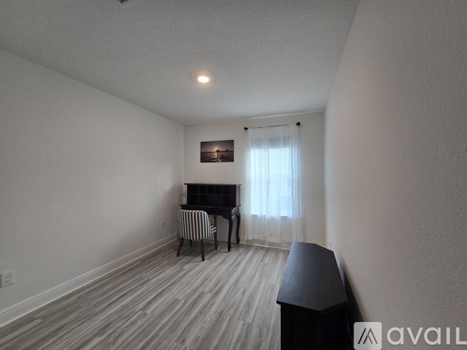 A room with a piano and a chair.