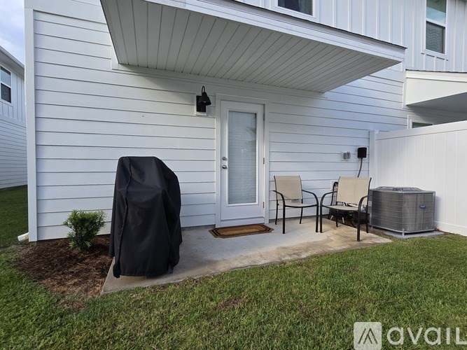 A white house with a black cover on a chair.