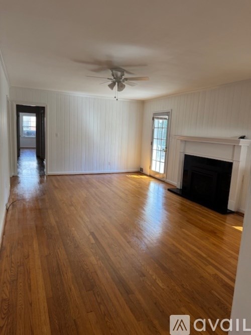 A room with wooden floors and a fireplace.